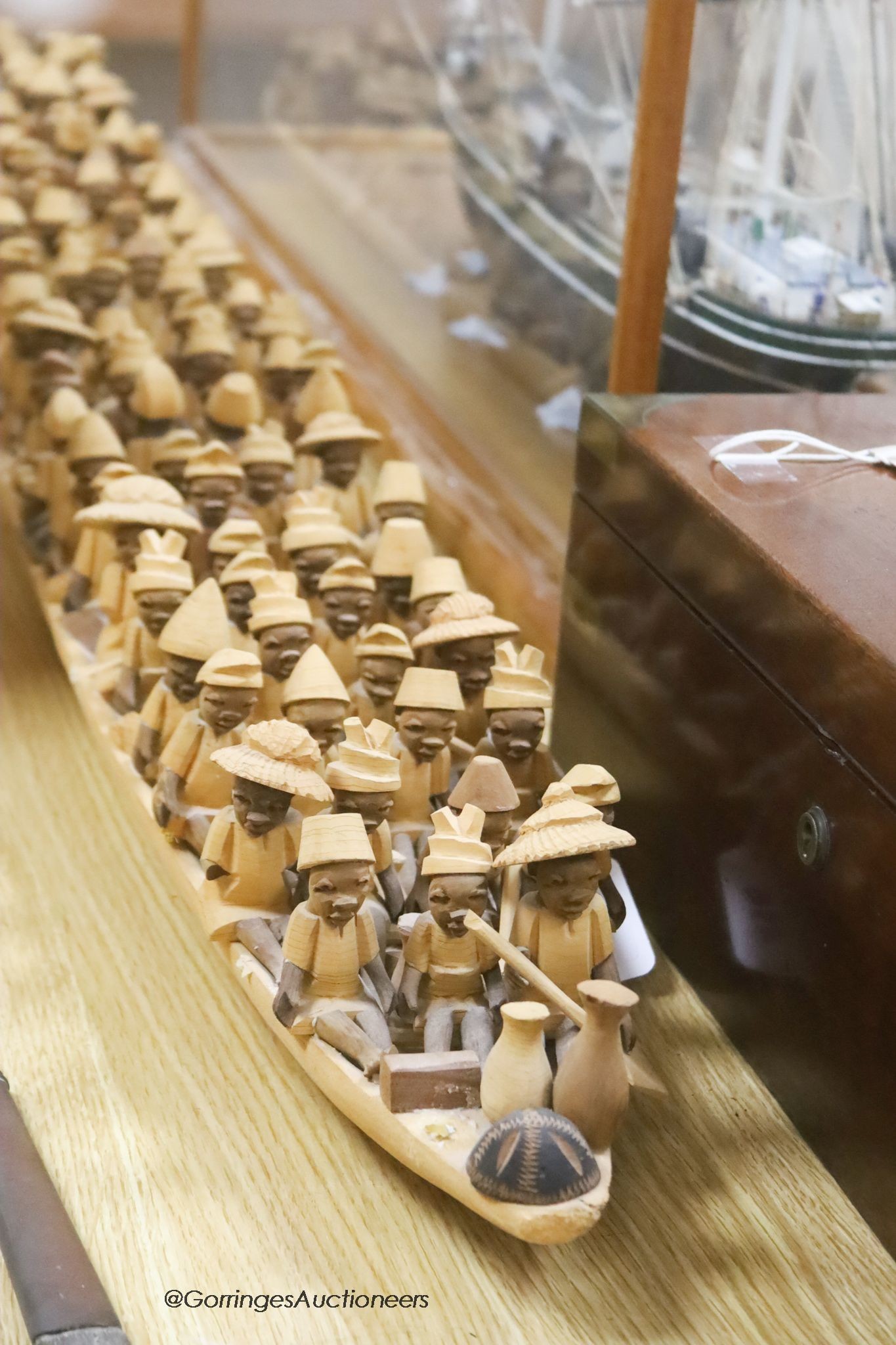 An African wood model of figures in a boat, length 155cm